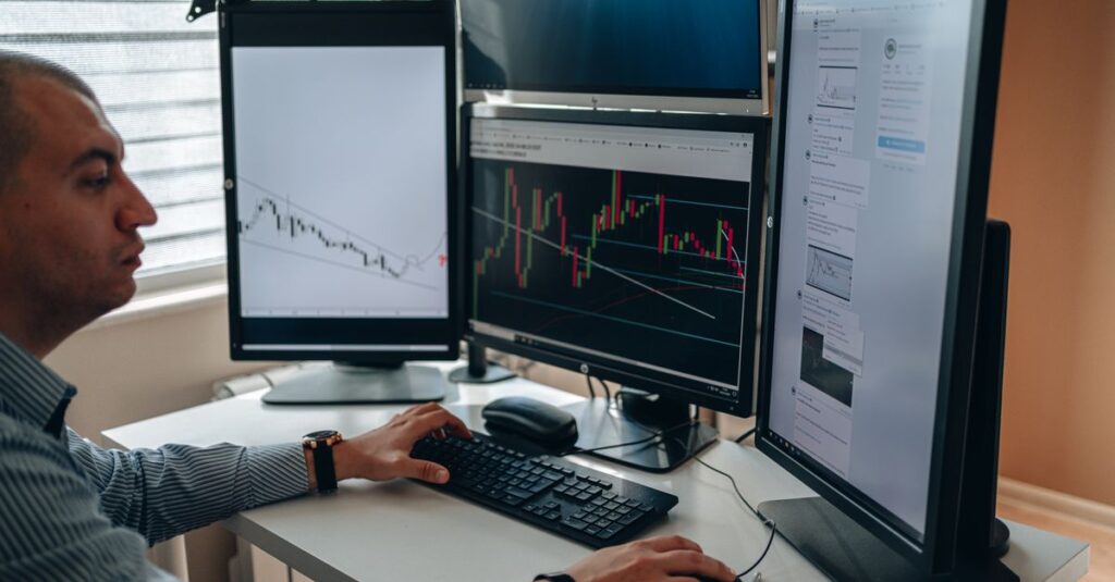 Forex trader reviewing charts across multiple monitors while comparing different RSI period settings