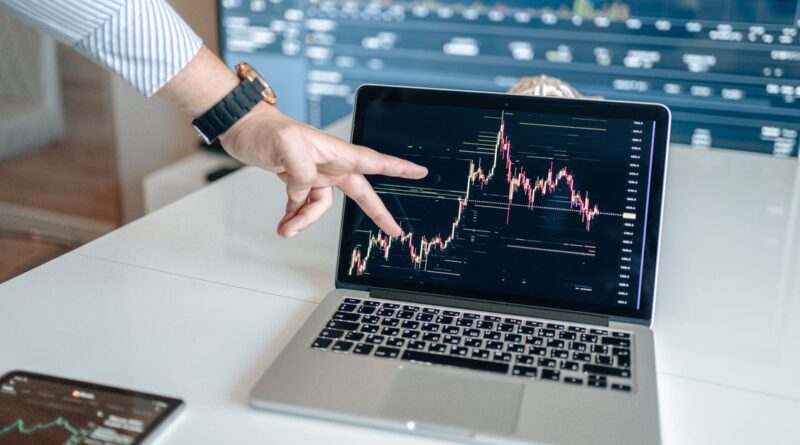 Forex price chart on a laptop with technical indicators overlaid, illustrating forex indicators explained