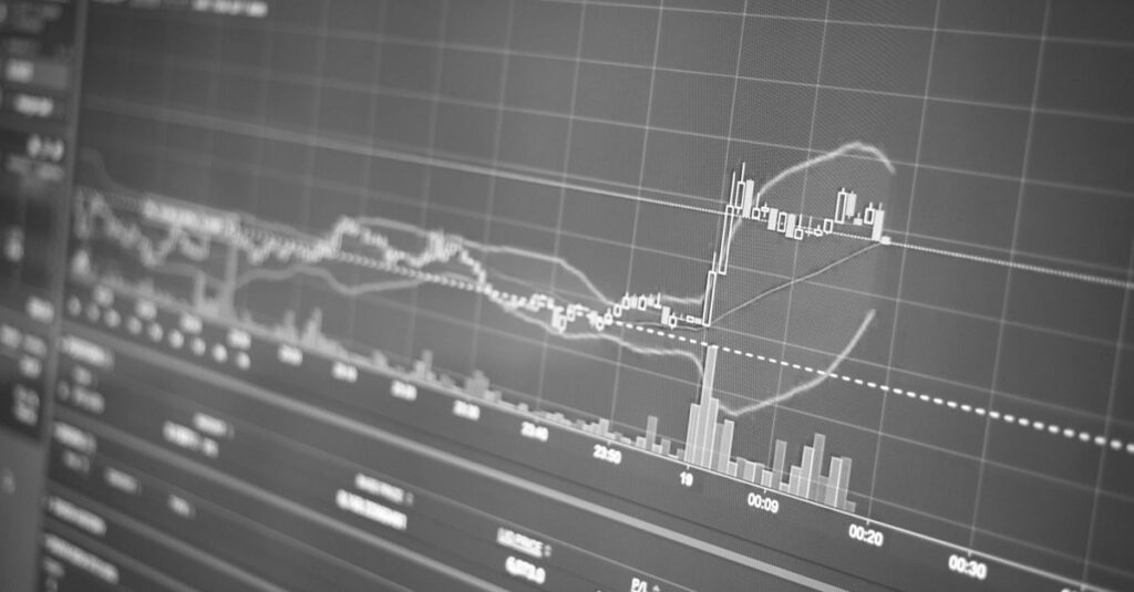 Gold bars beside a XAUUSD candlestick chart showing fast scalping signals on a trading screen